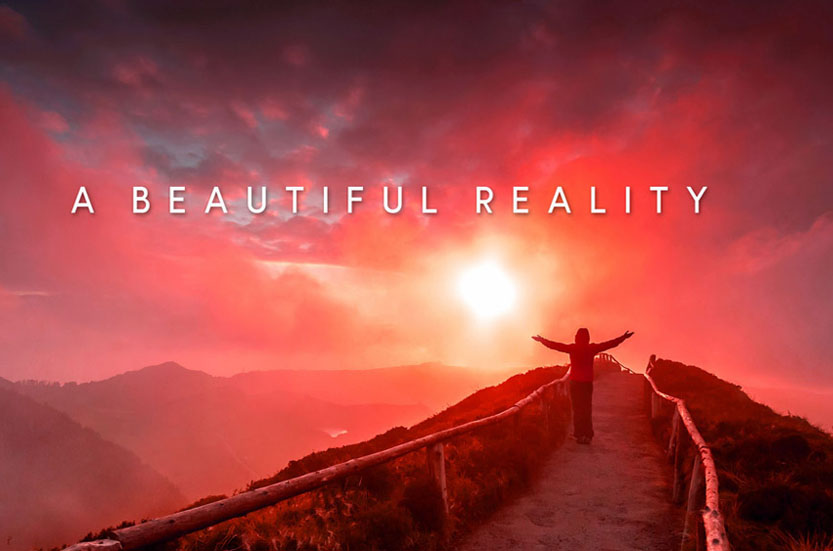 Free spirit woman standing on a hilltop facing a setting sun
