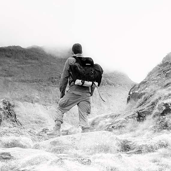Author Mark Woollacott ascending a path of steps in Snowdonia