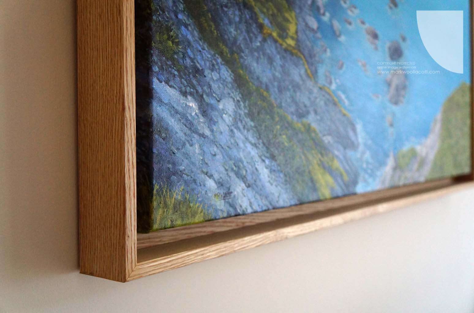 detail of The Cliffs at Flat Point painting, showing a corner of its wooden frame